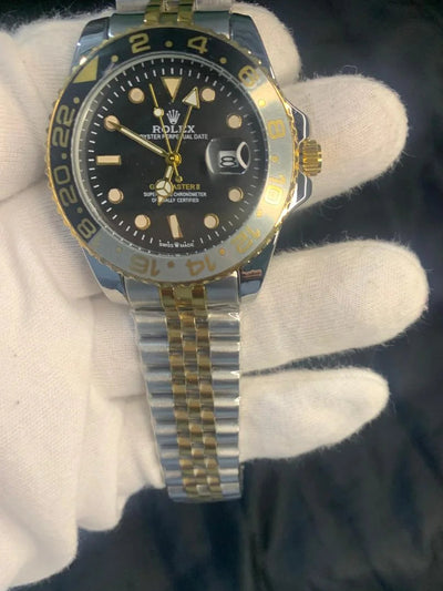 Rolex watch with black dial and gold accents on a white glove