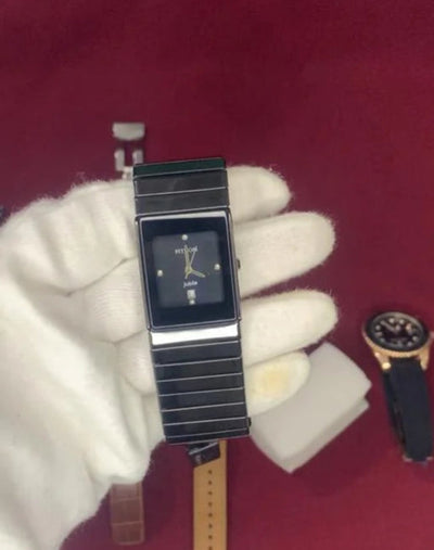 Wristwatch with different straps on a red background